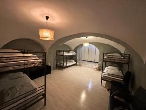 a room with three bunk beds in a room with a hallway at Hostel Sleeping Beauty in Ljubljana