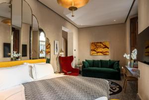 a bedroom with a bed and a green couch at Hotel Calimala in Florence