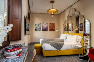 a bedroom with a large bed with a yellow headboard at Hotel Calimala in Florence