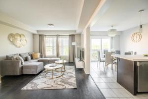 a living room with a couch and a table at GLOBALSTAY Modern 3 Bedroom House in Brampton in Brampton