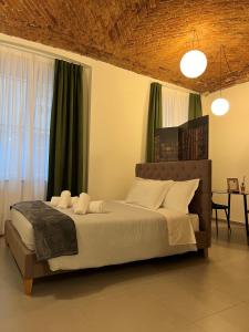 a bedroom with a large bed with green curtains at Porta Nuova Luxury Apartments in Turin