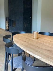 einem Holztisch mit Stühlen und einer Kaffeetasse darauf in der Unterkunft PENTHOUSE DURBUY APPART 10-12 Pers Vue Panoramique in Durbuy