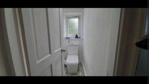 a bathroom with a white toilet in a room at Wingfield House 3 Bed in Greasbrough