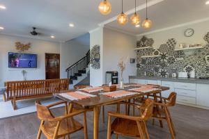 a kitchen and dining room with a wooden table and chairs at Belle Asana in Canggu