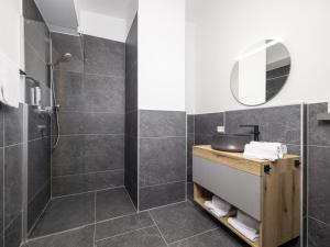 a bathroom with a shower and a sink and a mirror at Apartment Apartments Austria-18 by Interhome in Söll