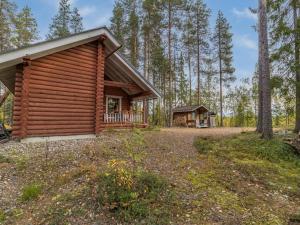 a log cabin in the woods with a porch at Holiday Home Kuukkelin tupa 1 by Interhome in Pyhätunturi