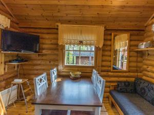 a dining room with a table and chairs in a cabin at Holiday Home Kuukkelin tupa 1 by Interhome in Pyhätunturi +11 photos