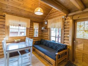 a living room with a couch and a table in a cabin at Holiday Home Kuukkelin tupa 1 by Interhome in Pyhätunturi