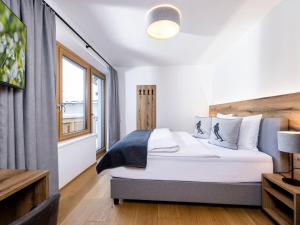 a bedroom with a bed and a window at Apartment Apartments Austria-5 by Interhome in Söll
