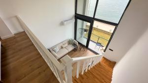 a white staircase with a couch and a large window at Mehmetbey Çaka in Perşembe