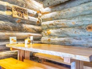 a wooden wall with a table and a bench at Holiday Home Kelokoto by Interhome in Saariselka +10 photos