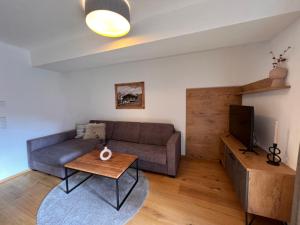 a living room with a couch and a table at Apartment Superior Bergblick 14 by Interhome in Söll