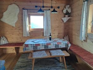 a dining room with a table and a window at Chalet Nasenalmhütte by Interhome in Hippach +34 photos