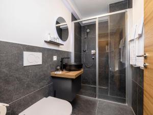 a bathroom with a shower and a toilet and a sink at Apartment Kleines Bergblick 15 by Interhome in Söll