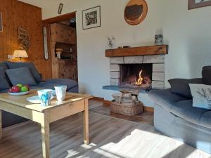 a living room with a couch and a fireplace at Apartment Résidence 25 by Interhome in Champex