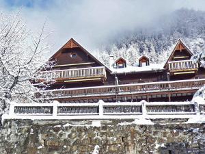 a large building with snow on the roof at Apartment Résidence 25 by Interhome in Champex
