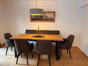 a dining room with a wooden table and chairs at Apartment Family 03 by Interhome in Söll
