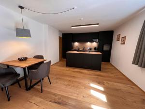 a kitchen and dining room with a table and chairs at Apartment Family 03 by Interhome in Söll +29 photos