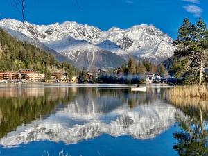 a view of a lake with snow covered mountains at Apartment Résidence 25 by Interhome in Champex