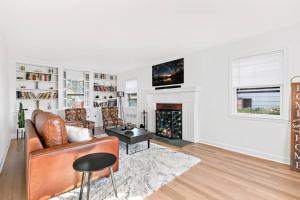 a living room with a couch and a fireplace at Fire pit ~ Game Room ~ near NYC ~ Modern Luxury in New Rochelle