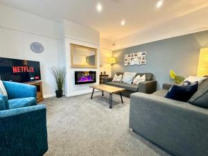 a living room with two couches and a tv at Crocus Cottage in York