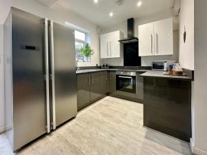 a kitchen with a large stainless steel refrigerator at Crocus Cottage in York