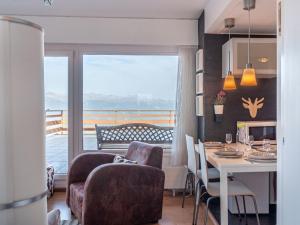 a kitchen and dining room with a table and a balcony at Apartment Olympic C7 by Interhome in Nendaz +30 photos