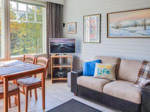 a living room with a couch and a tv at Holiday Home Moitakuru a6 by Interhome in Saariselka