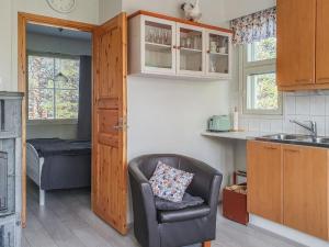 a kitchen with a chair and a sink at Holiday Home Moitakuru a6 by Interhome in Saariselka +11 photos