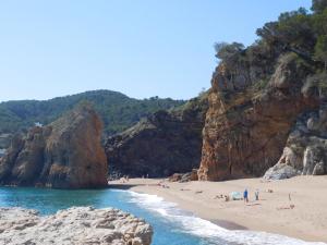 a group of people on a beach near the water at Apartment Melis III by Interhome in Pals