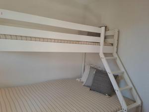 a white bunk bed with a ladder in a room at Apartment Beausoleil by Interhome in Verbier