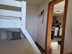 a bunk bed in a room with a mirror at Apartment Beausoleil by Interhome in Verbier