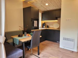 a small kitchen with a wooden table and a dining room at Holiday Home Soul & Lake by Interhome in Wemding