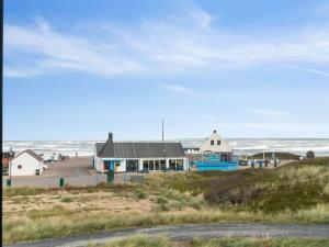 Torsted的住宿－Holiday Home Unge - 75m from the sea in NW Jutland by Interhome，海滩上的建筑,以海洋为背景