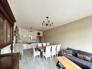 a living room with a couch and a table and chairs at Apartment Anno 1529 - Malzmönch Laurentius by Interhome in Zittau