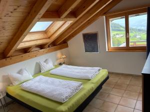 a bedroom with two beds in a attic at Apartment Penthouse Brugg by Interhome in Amden