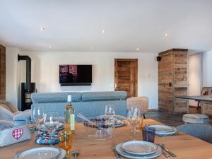 a living room with a table with wine glasses on it at Apartment Ferme D'Alice A2 by Interhome in Nendaz