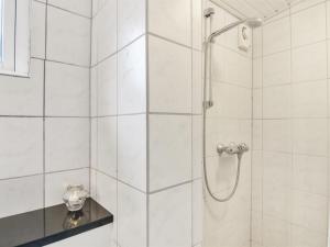a bathroom with a shower with a glass door at Apartment Heidel - 400m from the sea in NW Jutland by Interhome in Skagen
