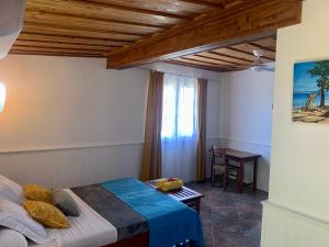 Postel nebo postele na pokoji v ubytování Saint Leu - Gîte Ylang Ylang - Bardzour