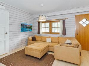 a living room with a couch and two chairs at Holiday Home Kulta-käkönen 3 by bomba by Interhome in Nurmes