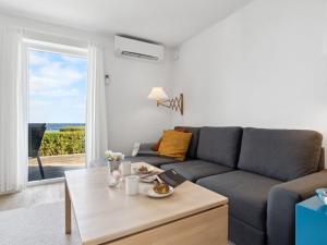 a living room with a couch and a table at Apartment Caisa - 75m from the sea in Bornholm by Interhome in Allinge