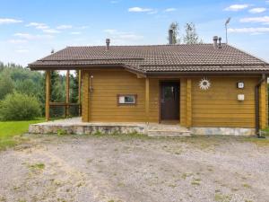 a small wooden house with a door in a yard at Holiday Home Himosaurinko by Interhome in Jämsä