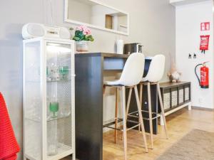 a kitchen with a counter and stools in a room at Holiday Home Skivillas 47 ukkohalla - a3 by Interhome in Hyrynsalmi