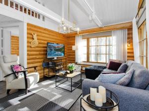 a living room with a couch and a tv at Holiday Home Honkakoli 4 by Interhome in Hattusaari