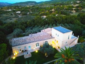 an aerial view of a large house with a blue roof at Villa Santa Margherita in Chiaramonte Gulfi