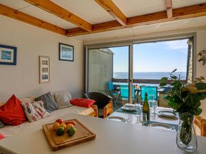 a living room with a table with fruit on it at Apartment Plein Océan-3 by Interhome in Carnac