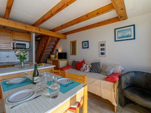 a living room with a couch and a table at Apartment Plein Océan-3 by Interhome in Carnac +14 photos