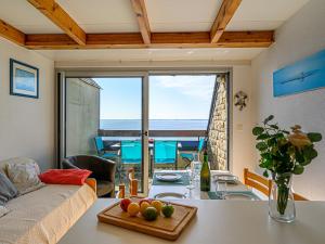 a living room with a table and a view of the ocean at Apartment Plein Océan-3 by Interhome in Carnac