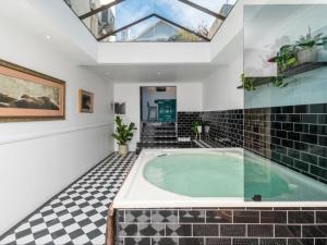 bañera de hidromasaje cubierta en una habitación con tragaluz en Belvedere House, en Ciudad del Cabo