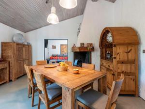 a dining room with a wooden table and chairs at Villa Villa Romana by Interhome in Porto-Vecchio